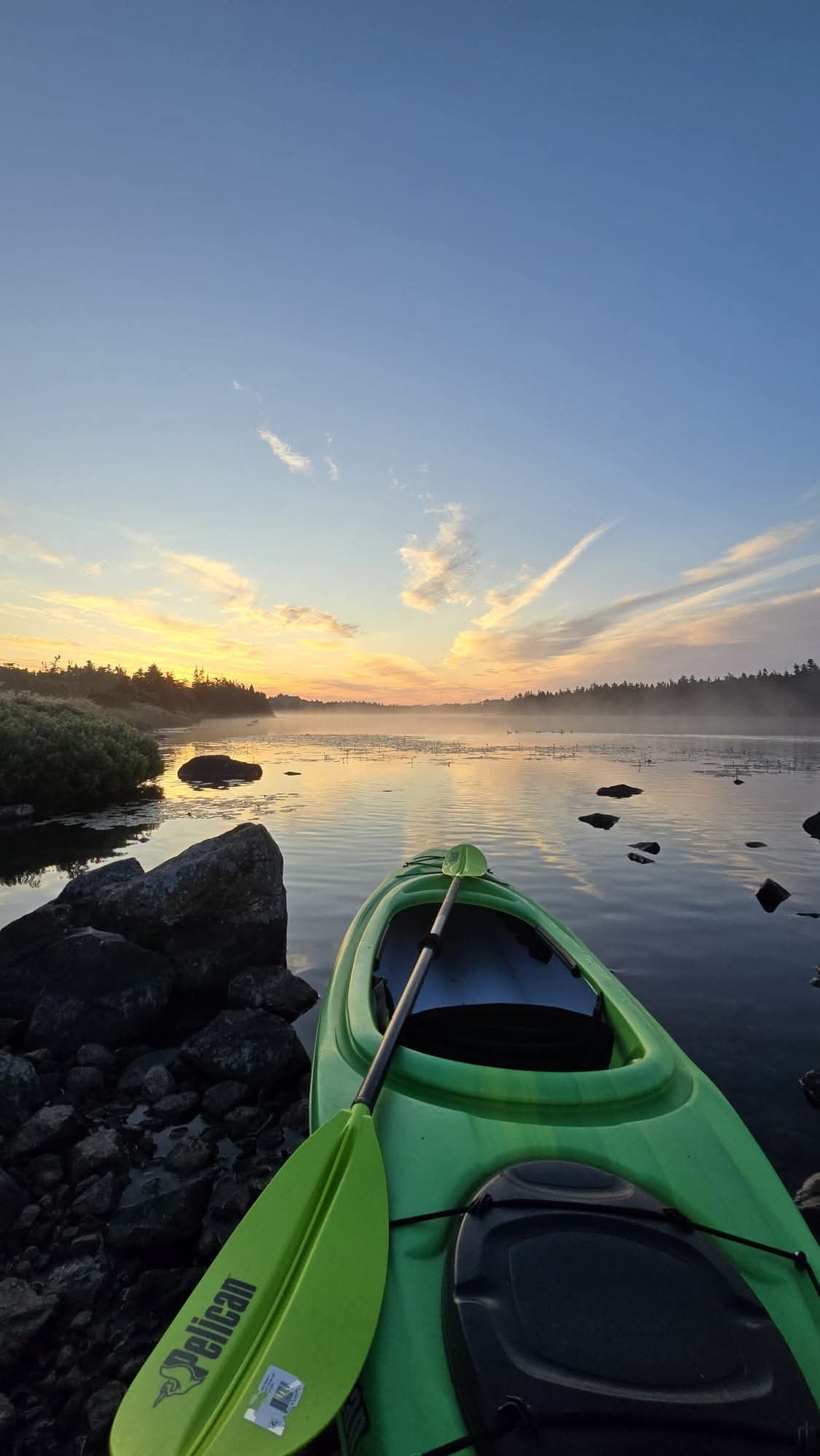 Paradise Paddles kayaks on the water near sunset.